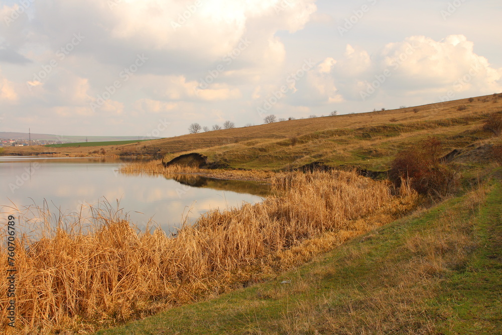 A river running through a grassy field A river running through a grassy field