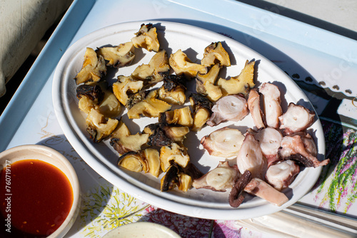 Boiled octopus and conch on a plate photo