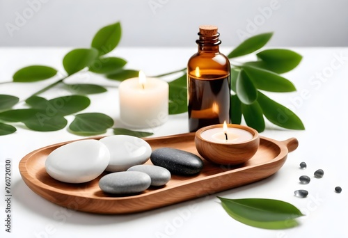 candles on wooden stands, several massage stones, small glass bottles, and green leaves on a white surface