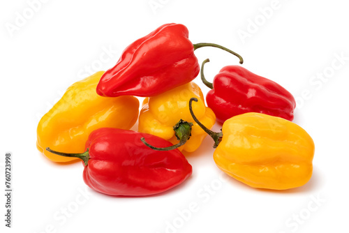 Mixture of fresh raw yellow and red Adjuma peppers close up isolated on white background photo