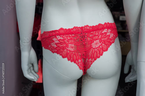 Closeup of red cheeky on mannequin in a fashion store showroom © pixarno