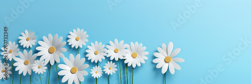Paper cut illustration of blooming daisies against light blue background. Beautiful paper art flowers, ideal as web banner for spring, summer and nature concepts. photo