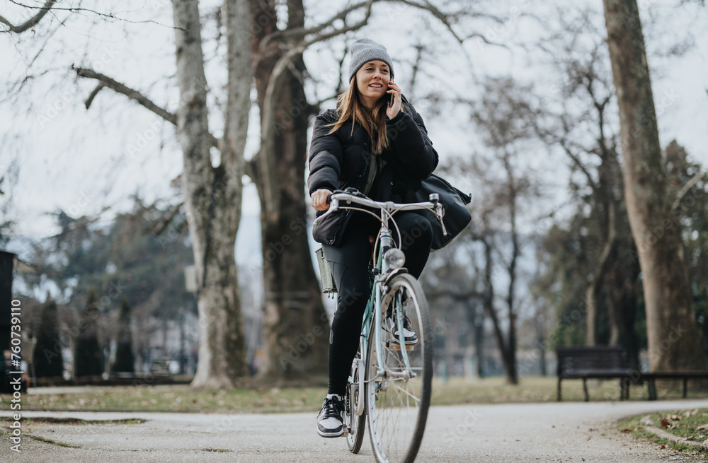 Cheerful young woman enjoying a leisure bike ride in the park during autumn. Cheerful young woman enjoying a leisure bike ride in the park during autumn.