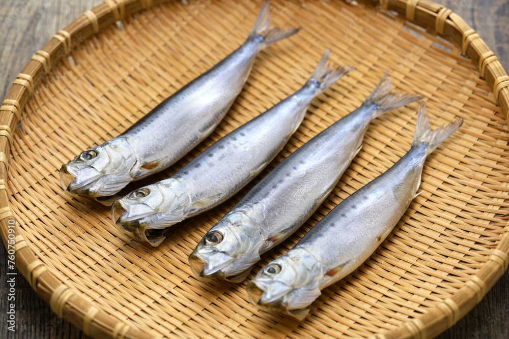 Iwashi marubosi ( semi-dried Japanese sardines ) isolated on a bamboo tray. Iwashi marubosi ( semi-dried Japanese sardines ) isolated on a bamboo tray.
