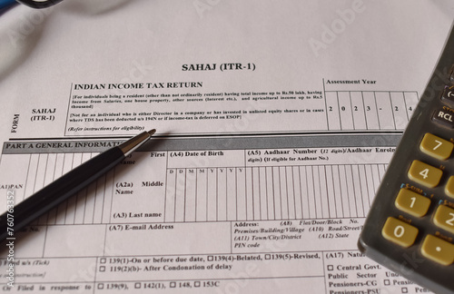 A closeup picture of ITR 1 forms on a table with a black pen on it.