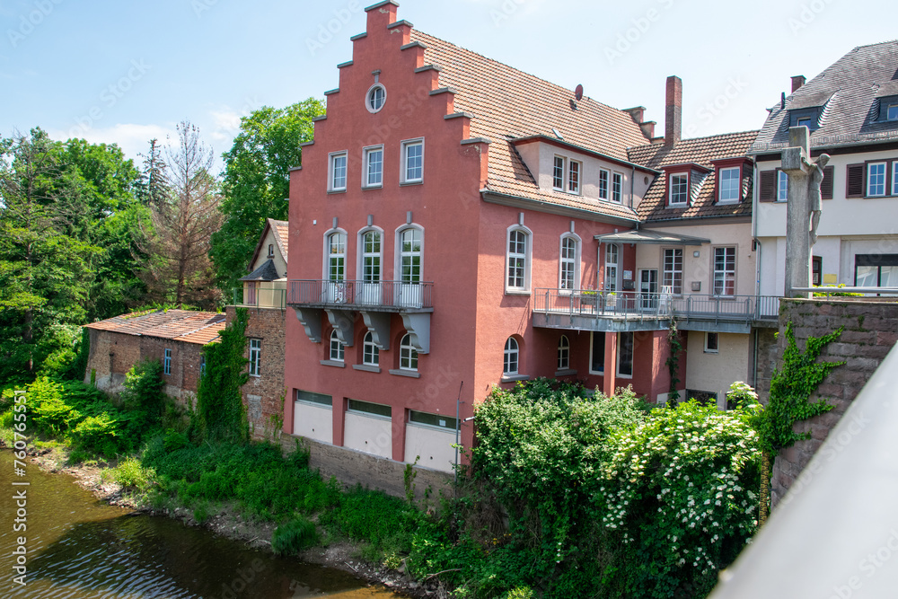 River embankment in Europe with cafe, houses and trees. River embankment in Europe with cafe, houses and trees.