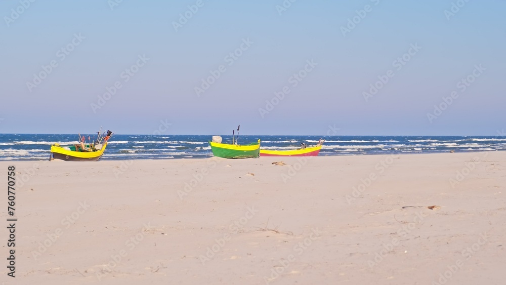 Undecked Handliner Fishing Vessel with Net Flags and Rusty Hooks Purse Sein Equipment Parked on Beach Sand at Seashore on Windy Spring Day