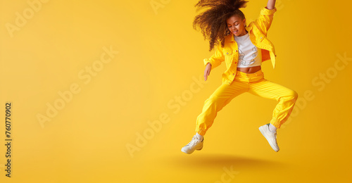 Young girl in colorful clothes dancing on the street