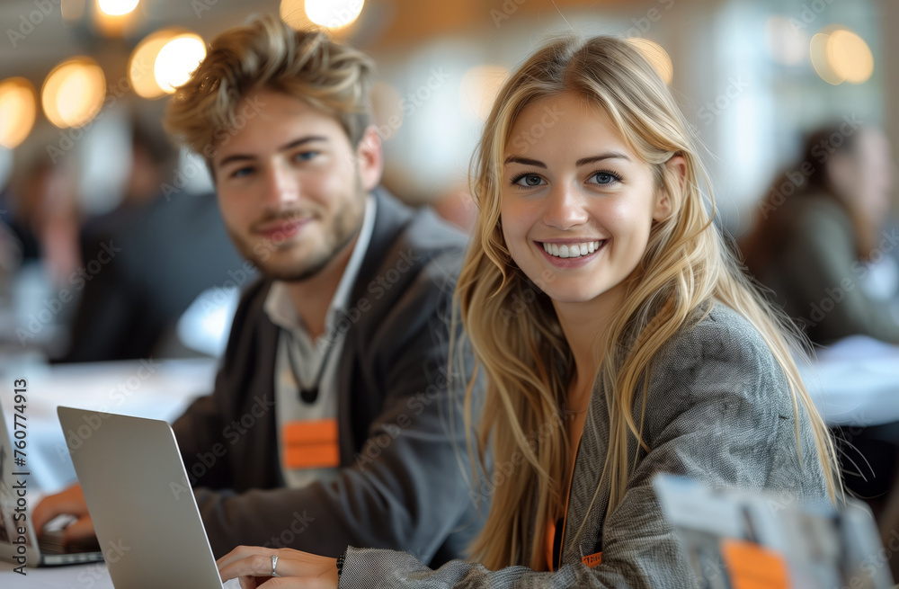 A man and a woman smiling at a laptop, having fun together A man and a woman smiling at a laptop, having fun together