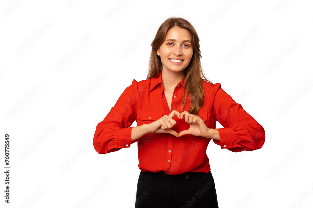 Fototapeta premium Studio shot of a young woman wearing red shirt holding heart gesture over her chest.