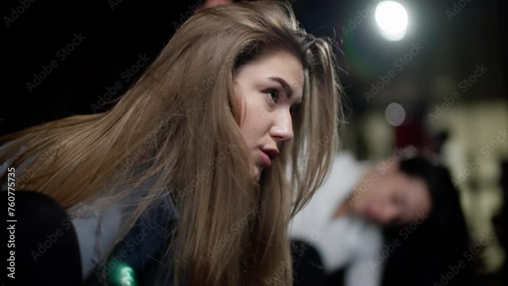 A woman with long brown hair is looking at the camera A woman with long brown hair is looking at the camera