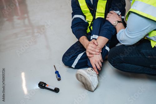 An engineer requests help following a team member's leg injury during electrical work.