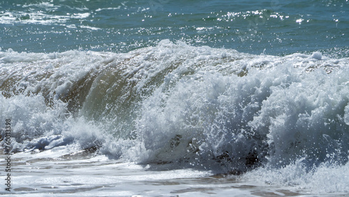 Foamy sea waves in strong winds.