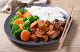 plate of fried tofu, rice and vegetables with sesame seeds