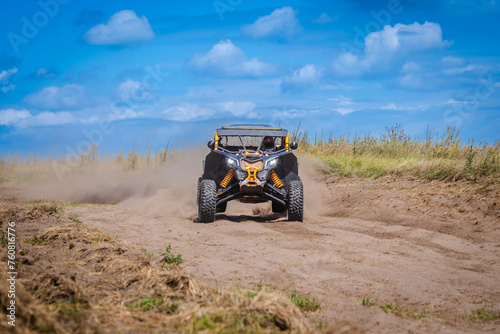 UTV buggy and 4x4 off road vehicle in sandy track. Buggy extreme riding