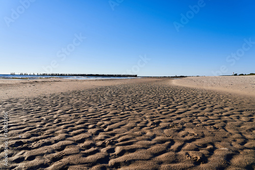 A sandy beach without water. The concept of an environmental disaster. Drought and disappearance of reservoirs