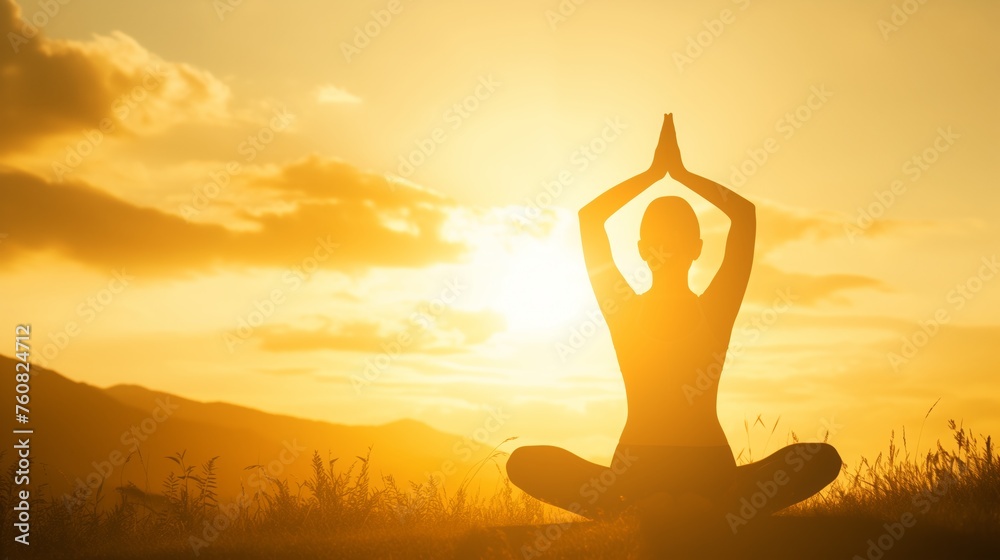 Person in yoga meditation pose in a serene field against a stunning sunset Person in yoga meditation pose in a serene field against a stunning sunset