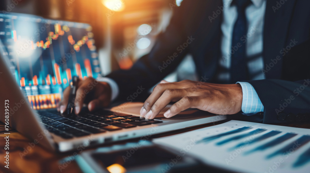 Fototapeta premium man checking stock market charts on the laptop, hands close up