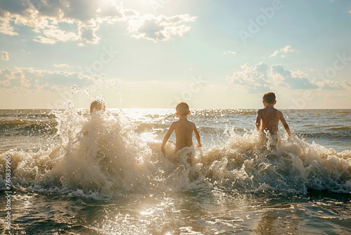 Children playing on the beach in the warm sunlight  photo