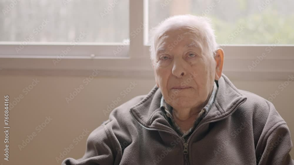 Aged man looking serious sitting on a geriatric