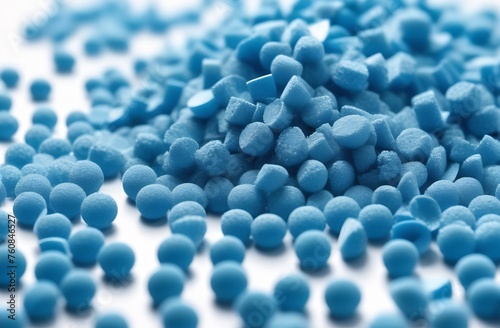 Close up of blue porous plastic granules on wooden table photo
