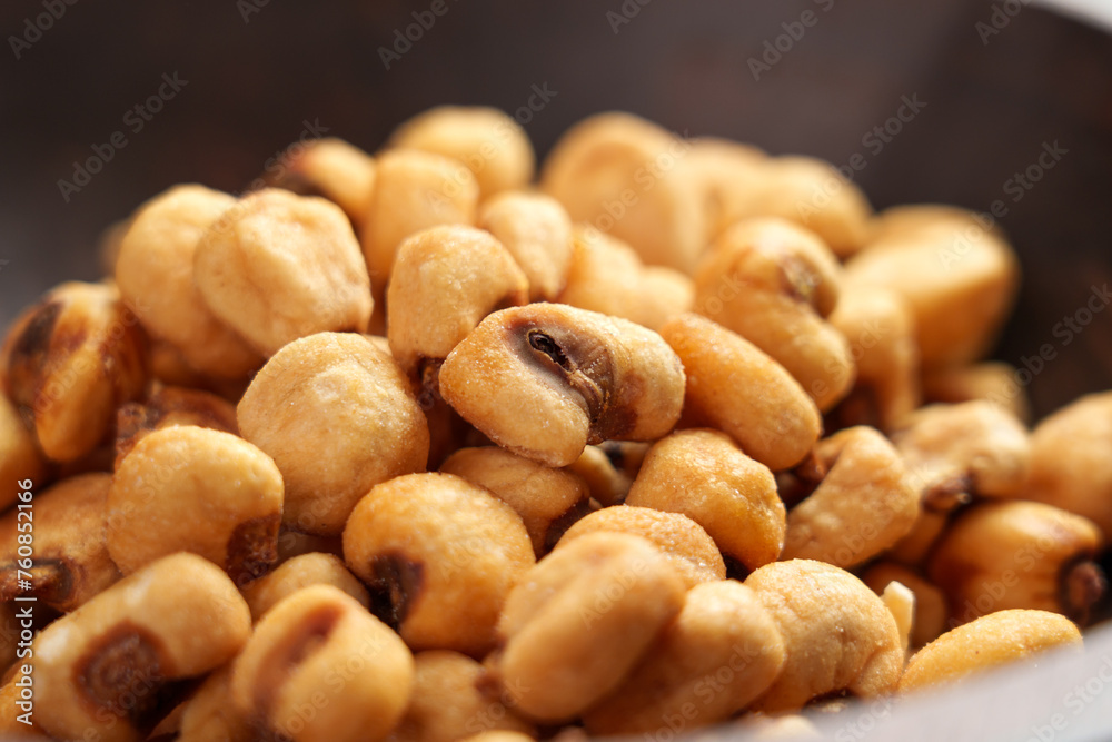 Organic salty roasted dried maize grains in wooden bowl. Tasty beer snack of fried corns Organic salty roasted dried maize grains in wooden bowl. Tasty beer snack of fried corns