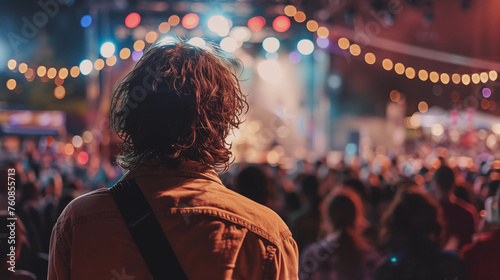 A man watching a show at a festival