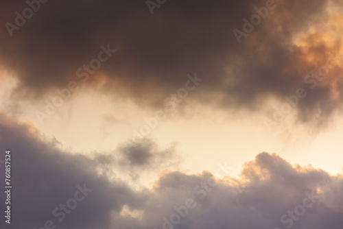 evening sky in orange glow. huge fluffy clouds. dramatic natural background