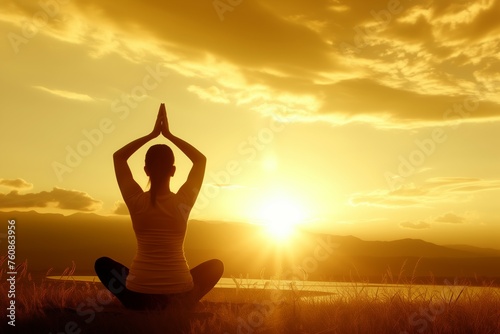 Person in a yoga meditation pose against the dramatic canvas of a sunset sky