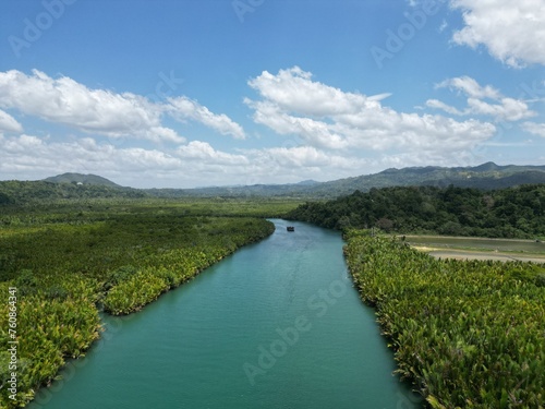 Bohol Loboc river cruise on Philippines. Palms, cloudy sky, hills photo