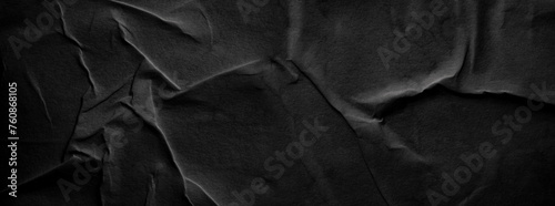 Wet black crumpled craft paper blank texture copy space horizontal long background.