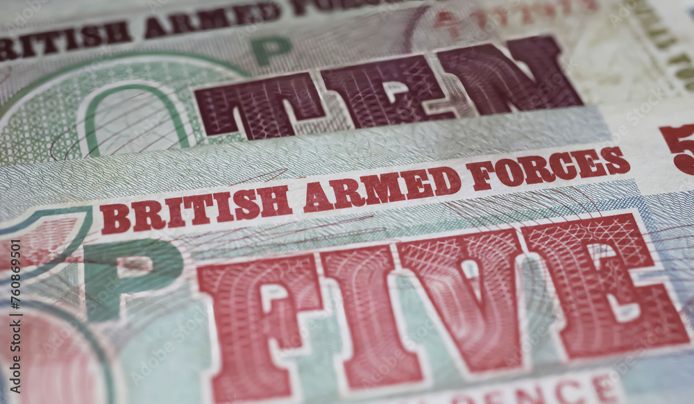 Obraz premium Closeup of old historical British Armed Forces banknotes (focus on center)