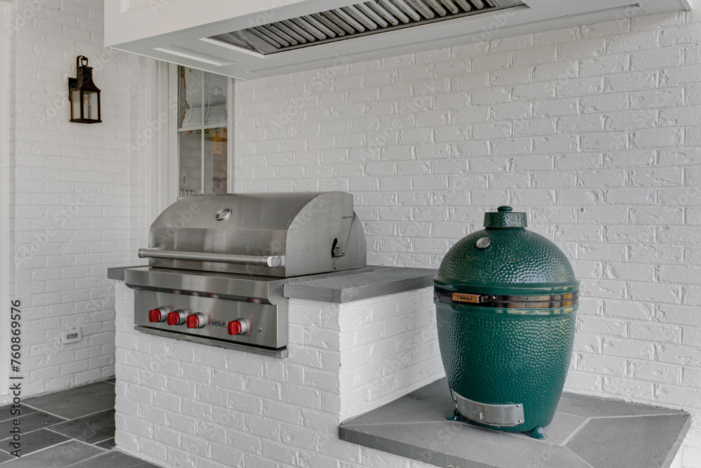High-Quality Stainless Steel Outdoor Kitchen Setup with Grill, Pizza Oven, Vent Hood, Brick Wall, Lantern, and Patio Flooring for Backyard Entertaining