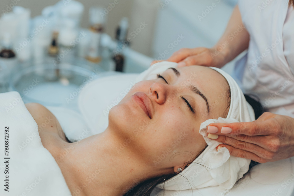 girl at a cosmetologist's office doing skin cleansing