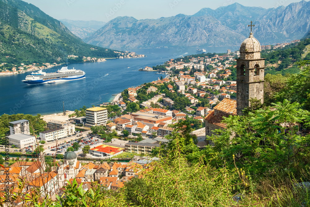 Kotor bay with medieval church and old town from Lovcen Mountain, Montenegro. Adriatic fjord with boats and cruise ship in summer day. Travel destination