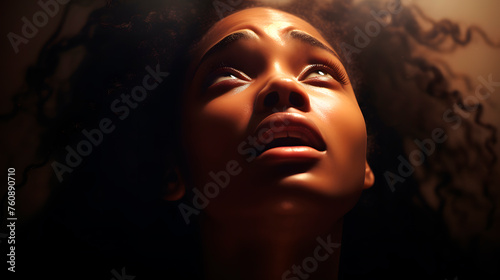 black woman pleading to the sky, afro woman concerned photo
