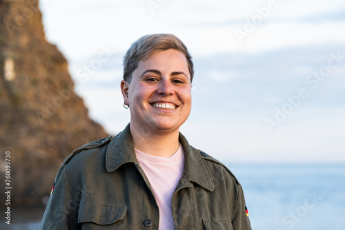 Joyful Seaside Portrait of a Young Non Binary Adult Person photo