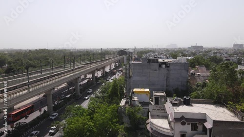 Metro train in delhi captital of india running at high speed in NCR region. fastest medium of transportation in crowded new delhi photo