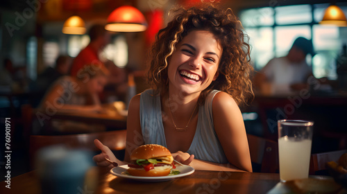 happy woman while eating a hamburger, happy woman at restaurant