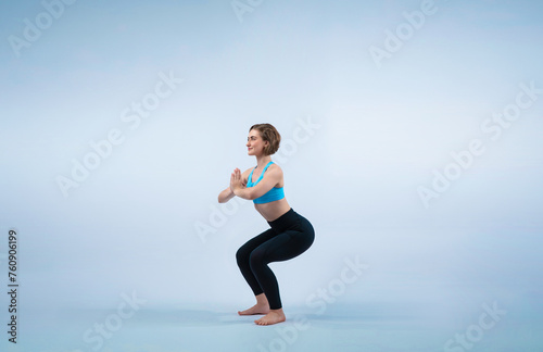 Fototapeta Naklejka Na Ścianę i Meble -  Full body length gaiety shot athletic and sporty woman doing healthy and meditative yoga exercise workout posture on isolated background. Healthy active and body care lifestyle
