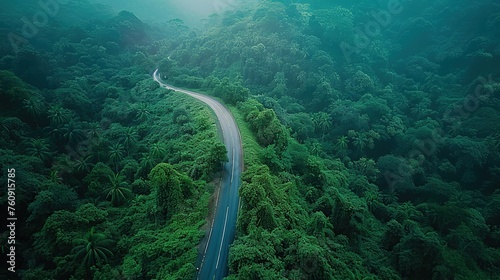 Aerial top view beautiful highway on green forest in the rain season