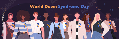 Every year on March 21th is the celebration of World Down Syndrome Day. A group of modern men and women stand together with yellow blue ribbons.