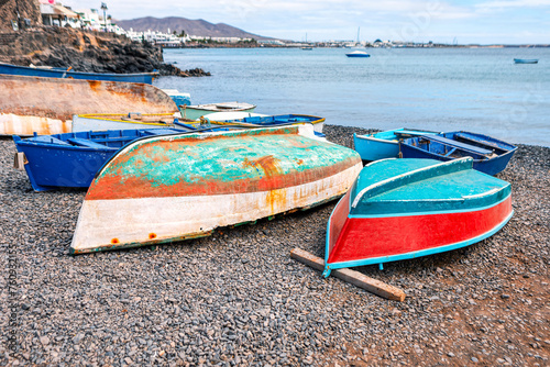 Colorful wooden fishing boats on the beach at the ocean. Fishing village boats photo