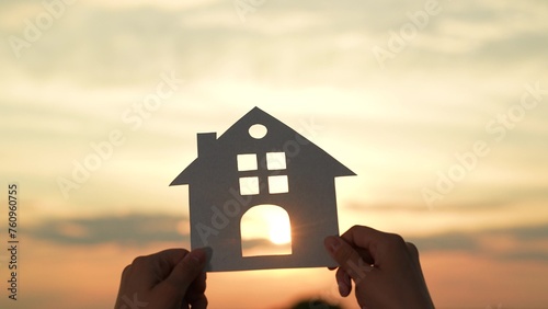 hands holding paper house, window sunset ray, happy family mortgage build new house, refinancing your mortgage, property market analysis, buying foreclosed homes, new neighborhood exploration photo