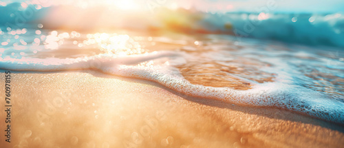 Sunlight glitters on the ocean waves and sandy beach, creating a sparkling effect. photo