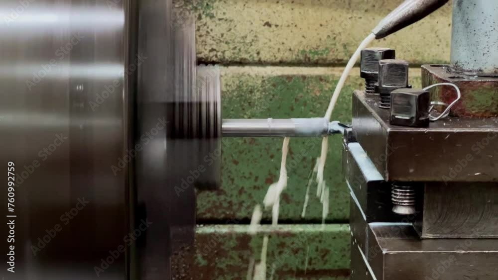 An iron rod being drilled using a milling machine. Using coolant to reduce excess heat in the iron rod. Close up shot. An iron rod being drilled using a milling machine. Using coolant to reduce excess heat in the iron rod. Close up shot.
