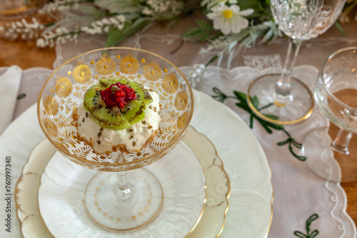 Mini cheesecake with kiwi, raspberry and edible gold garnish on a crystal gold compote