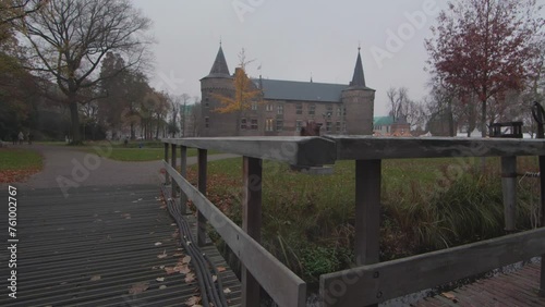 Castle at Kasteelpoort, Helmond, in the back. Nature, focus on a fence. photo