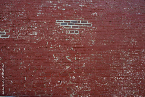 Red painted brick wall with exposed bricks