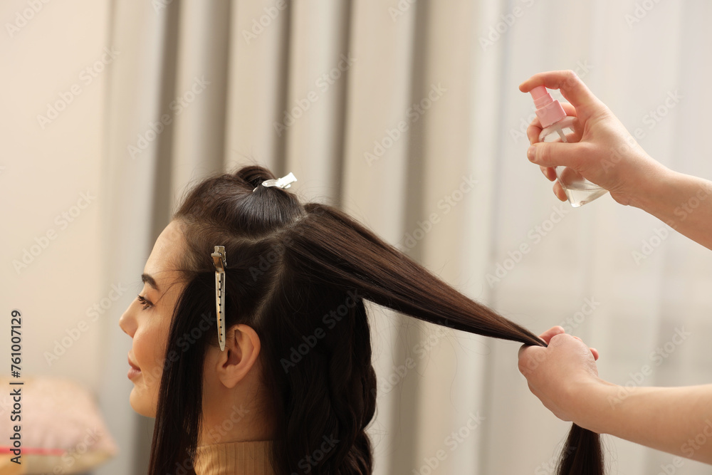 Naklejka premium Hair styling. Professional hairdresser working with client in salon, closeup